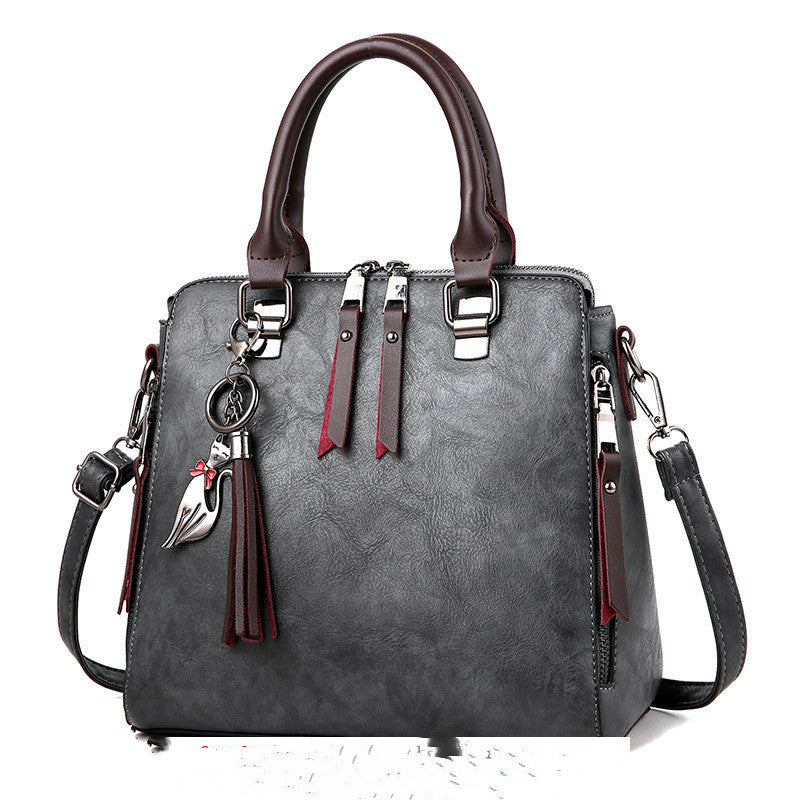 Vintage-Henkeltasche mit Quaste in Grau