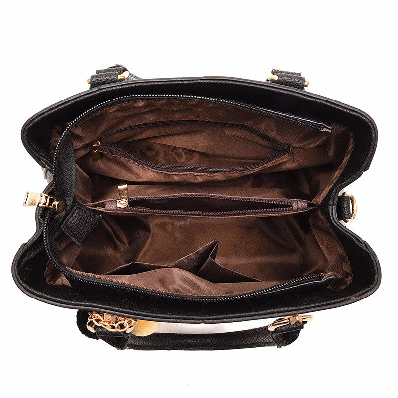 Henkeltasche mit Flechtprägung und Pompon-Anhänger
