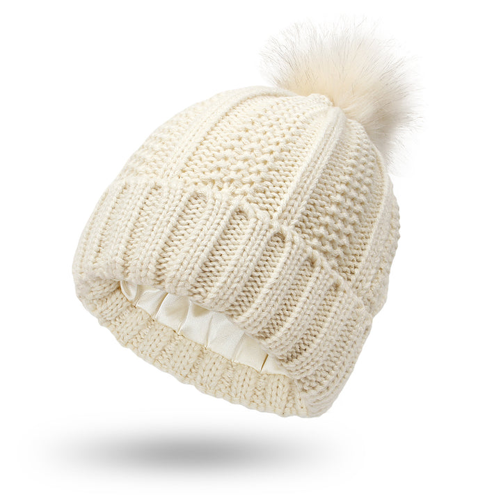 Grobstrick-Mütze mit Fellbommel in Beige